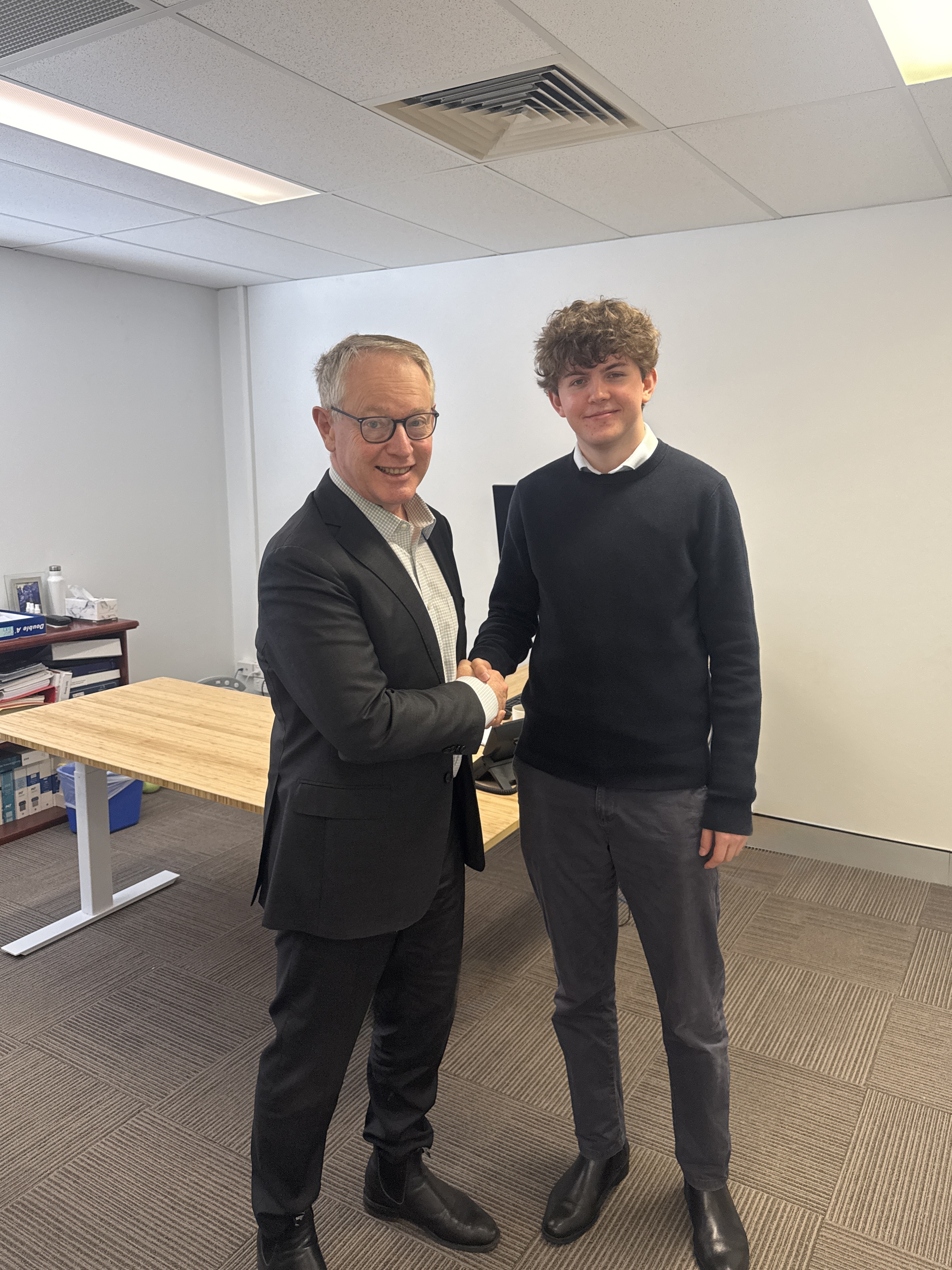 Andrew Lovett and Evyn standing together at the office