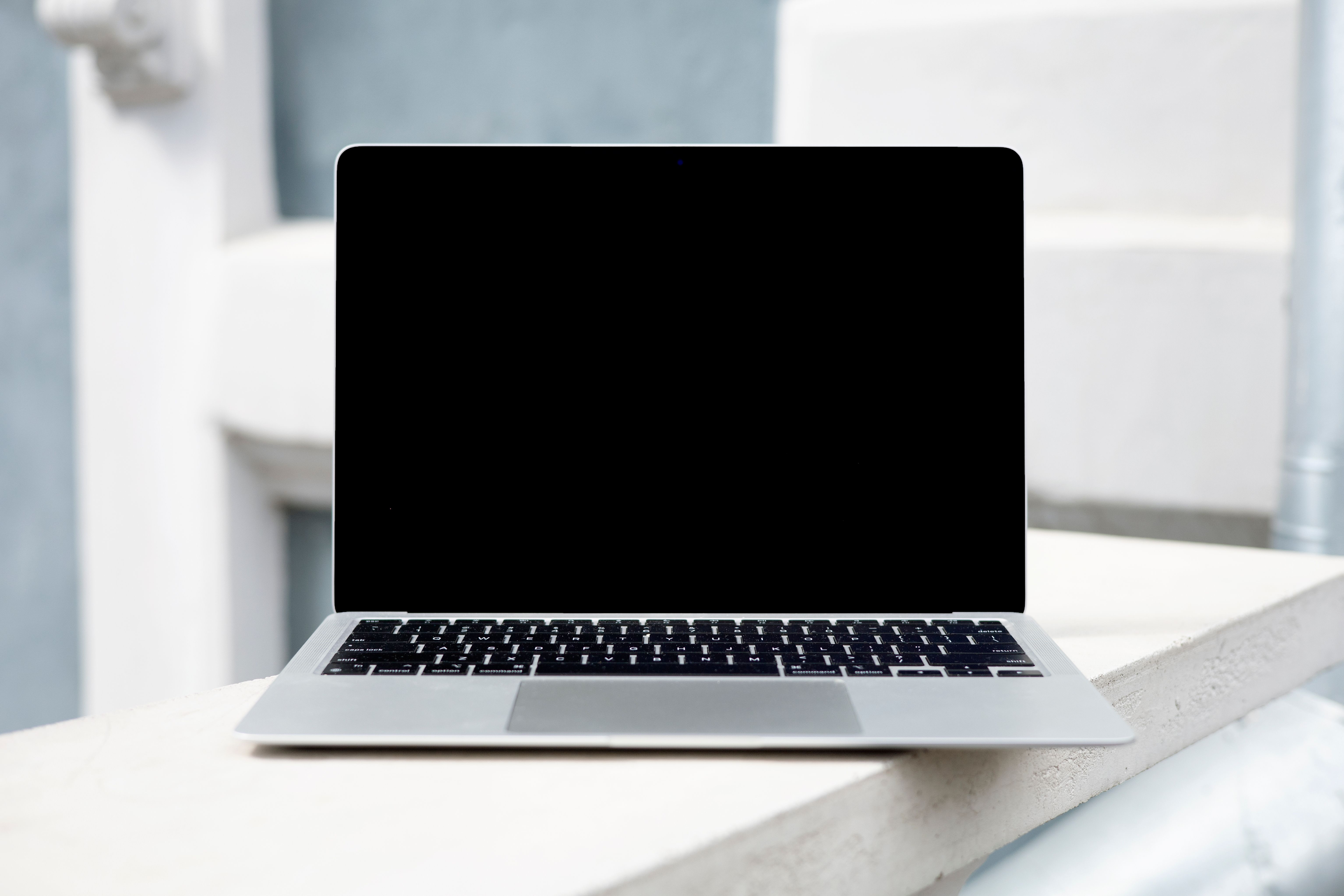 Open laptop on a windowsill